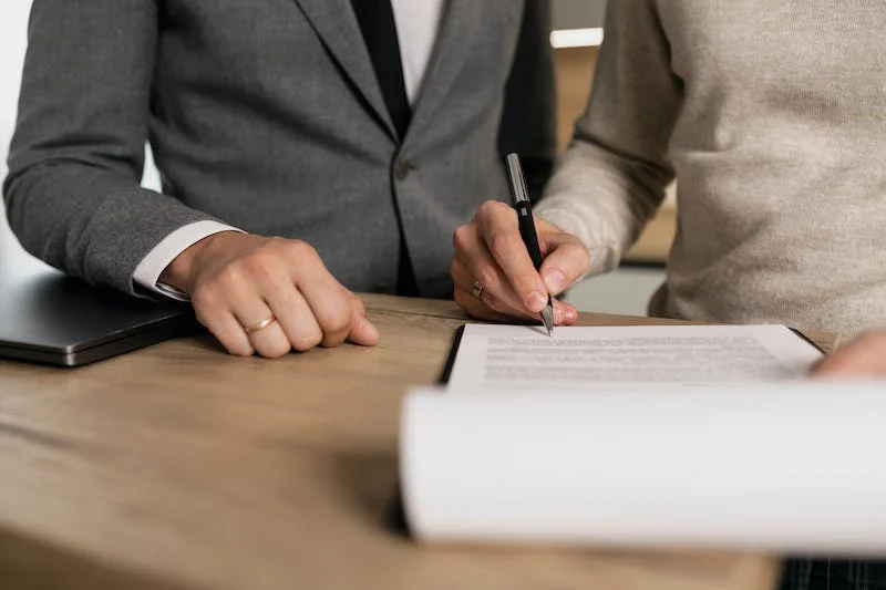  a couple signing a prenuptial agreement