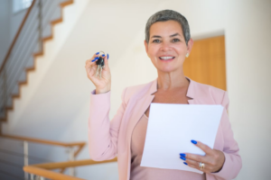real estate agent handing over a key to the new homeowner