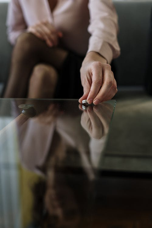  A woman taking off her wedding ring.