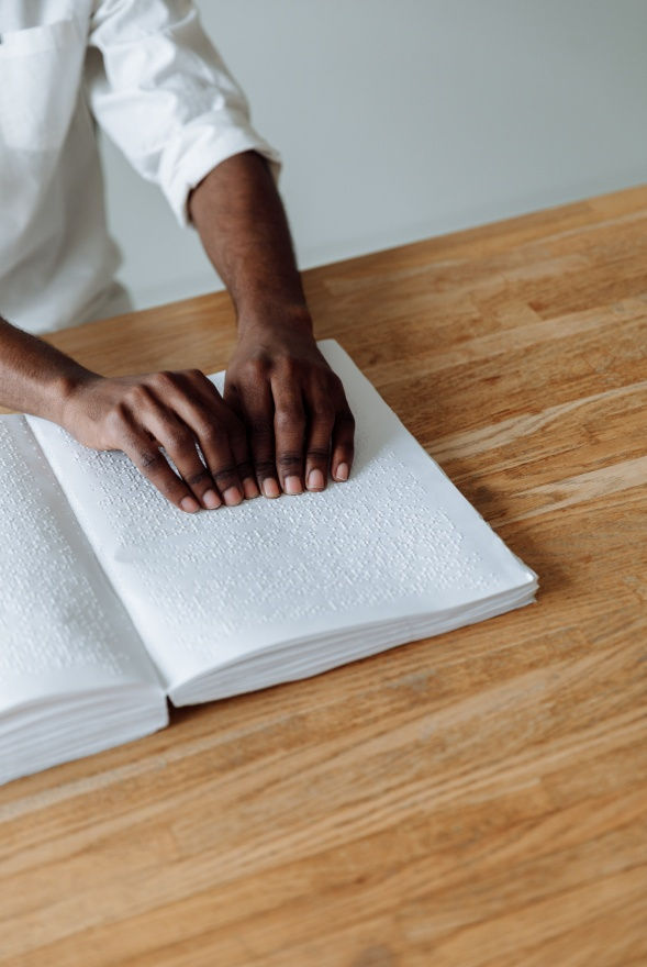  A man reading a Braille book