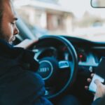 Nanda & Associate Lawyers Canada - Person using a mobile phone while driving