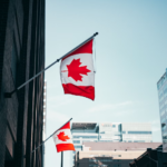 Nanda & Associate Lawyers Canada - An image of Canada’s flags on a building
