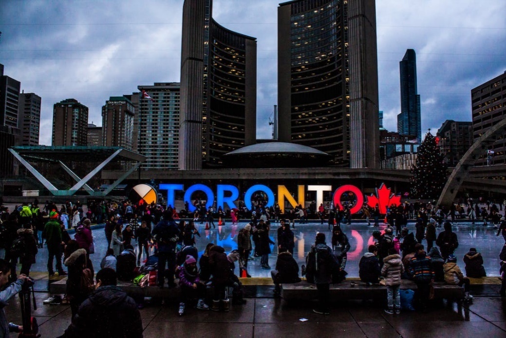 People gathered near a Toronto freestanding signage.