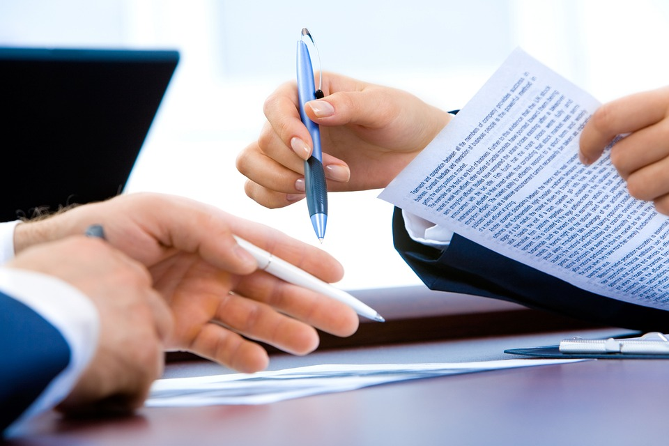 Nanda & Associate Lawyers Canada - A person about to sign a document