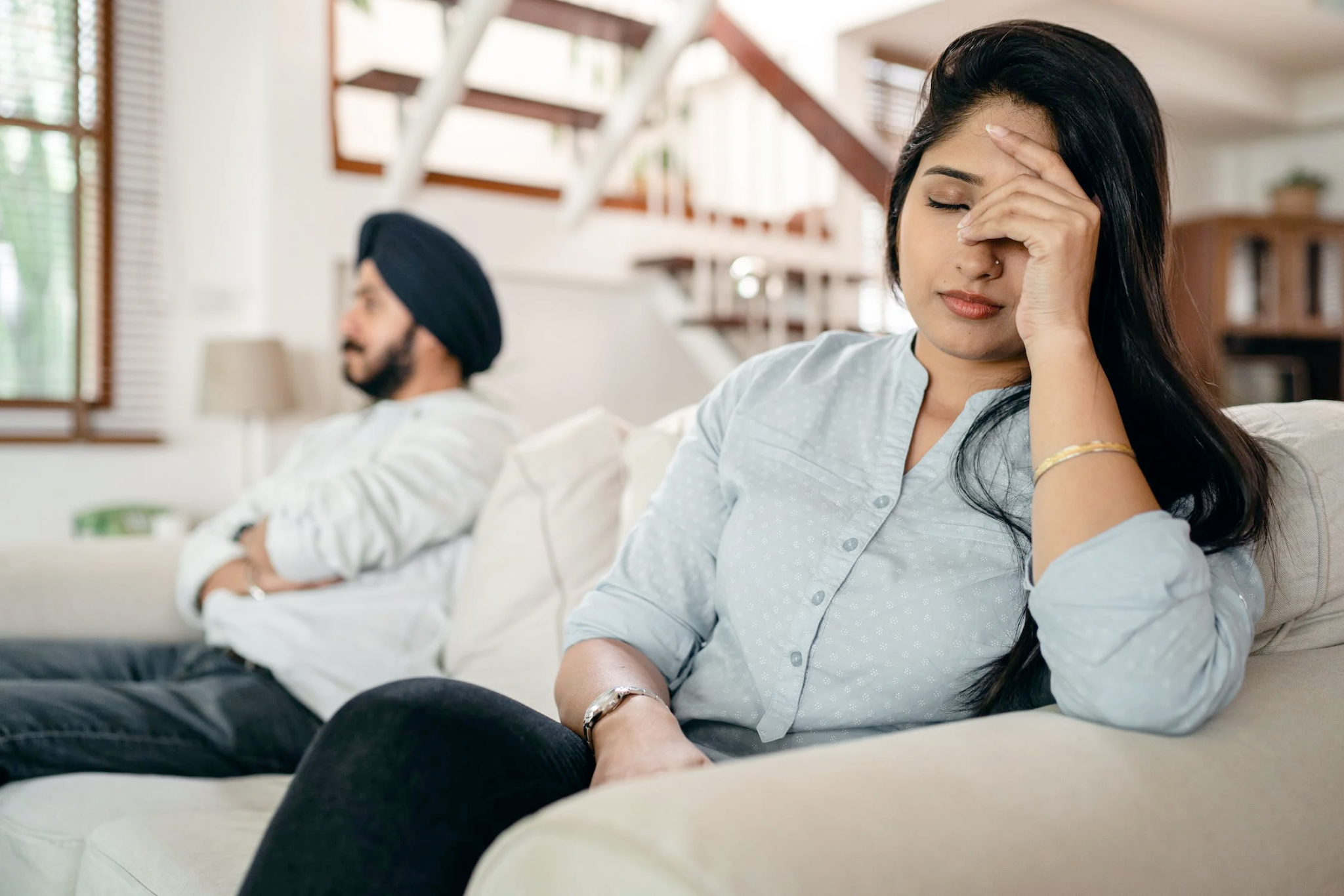 Nanda & Associate Lawyers Canada - An image of a man and woman sitting on the couch looking after a conflict