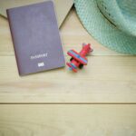 Nanda & Associate Lawyers Canada - Backside of a Canadian passport, a toy plane, and a hat