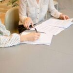 Nanda & Associate Lawyers Canada - Women signing contracts