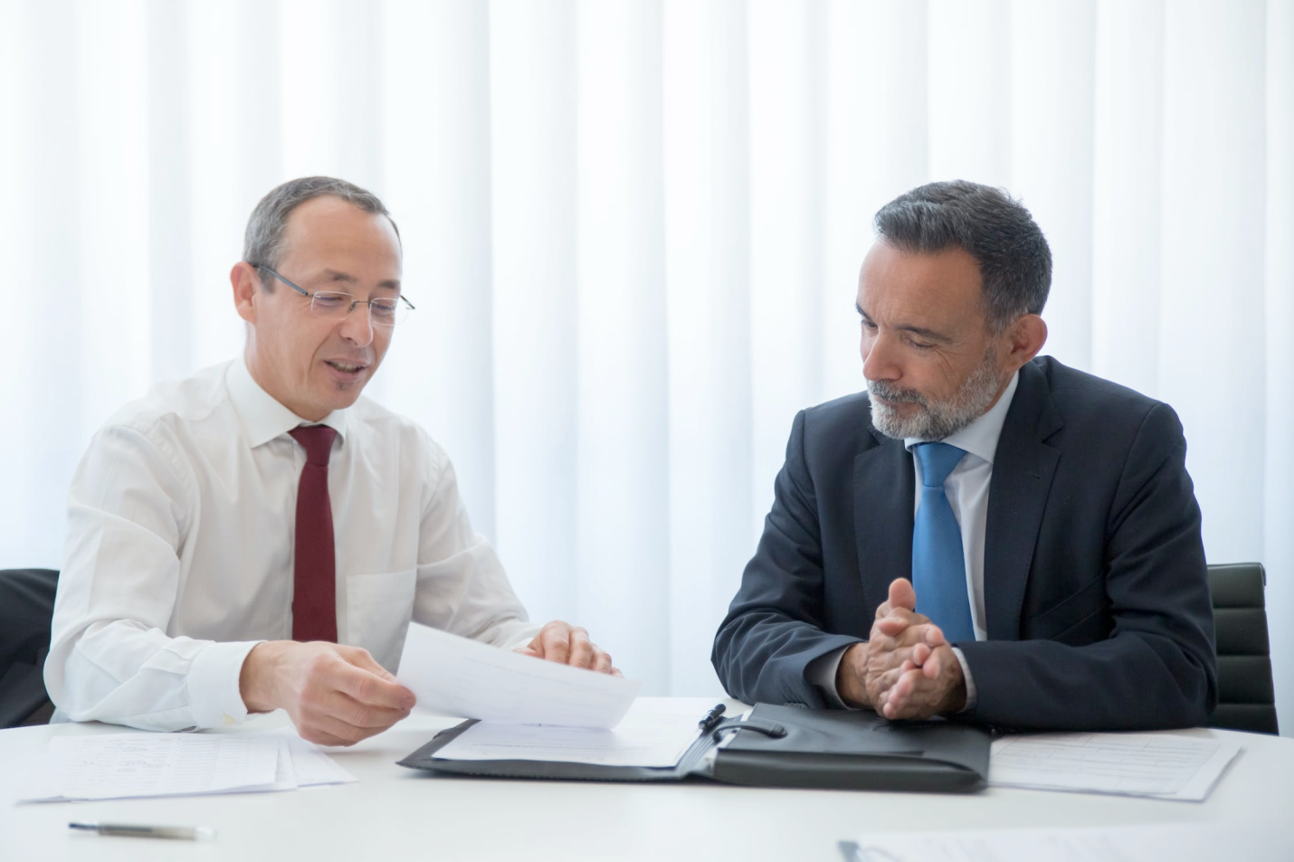 Nanda & Associate Lawyers Canada - An image of two people discussing a contract