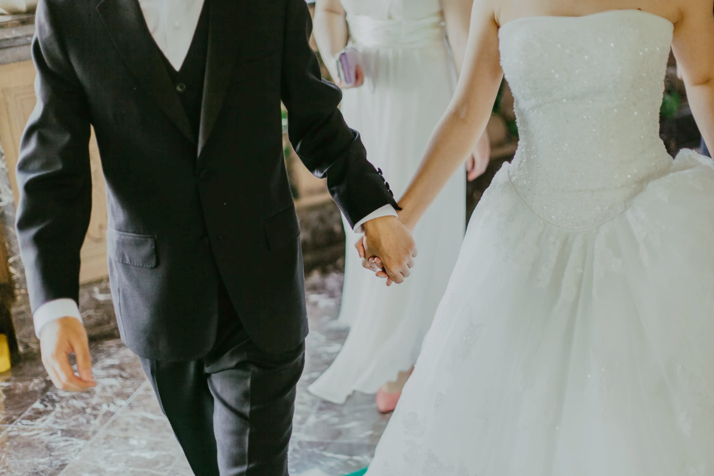 Nanda & Associate Lawyers Canada - An image of a couple holding hands at their wedding