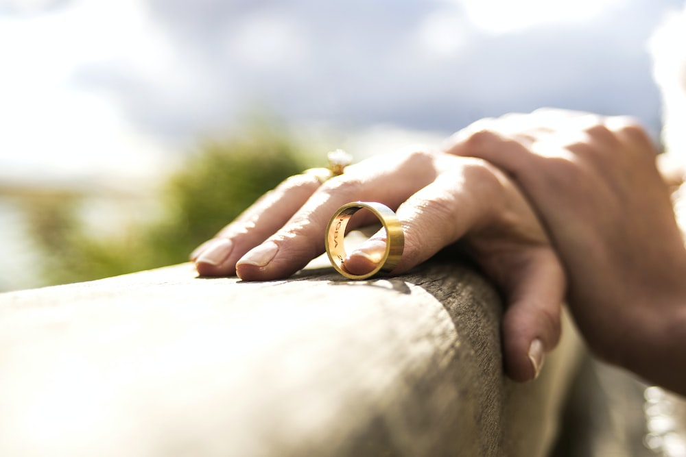 Nanda & Associate Lawyers Canada - a woman holding a wedding ring with a finger