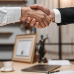 Nanda & Associate Lawyers Canada - A civil litigation lawyer shaking hands with a client