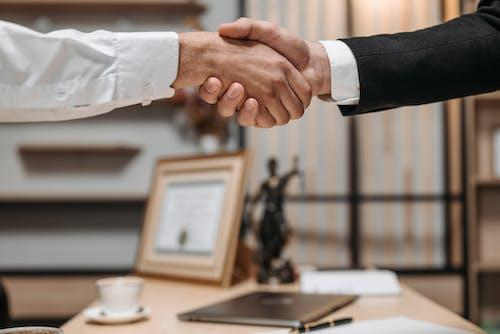 Nanda & Associate Lawyers Canada - A civil litigation lawyer shaking hands with a client