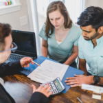 Nanda & Associate Lawyers Canada - A real estate lawyer explaining the home-buying deal to the buyers