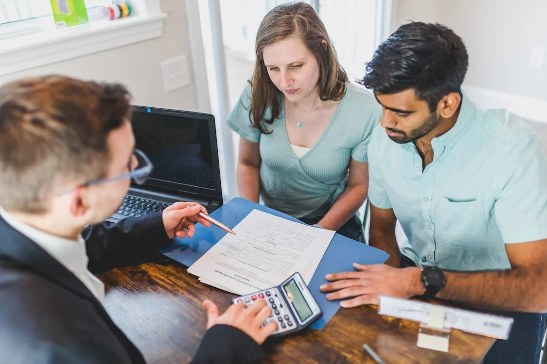 Nanda & Associate Lawyers Canada - A real estate lawyer explaining the home-buying deal to the buyers