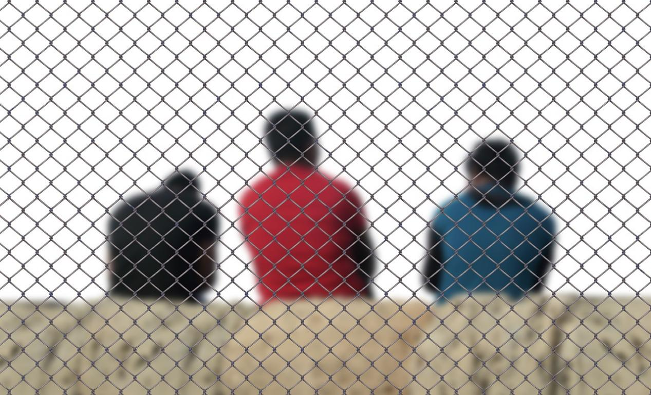 Nanda & Associate Lawyers Canada - Three people behind a cage wall