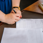 Nanda & Associate Lawyers Canada - A person signing documents