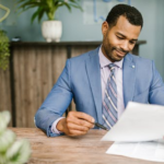 Nanda & Associate Lawyers Canada - an immigration lawyer looking at a document