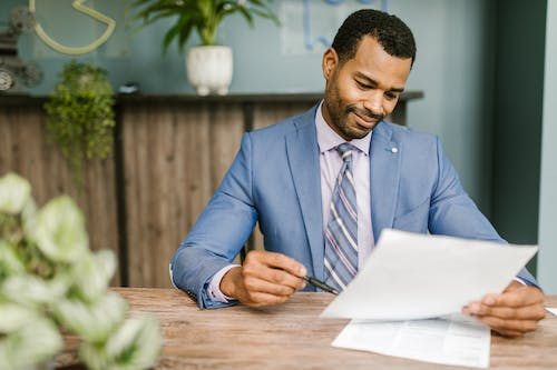 Nanda & Associate Lawyers Canada - an immigration lawyer looking at a document