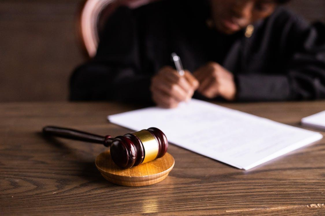 Nanda & Associate Lawyers Canada - A judge signing documents