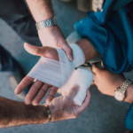 Nanda & Associate Lawyers Canada - A person carefully applying a bandage on another person's personal injury.