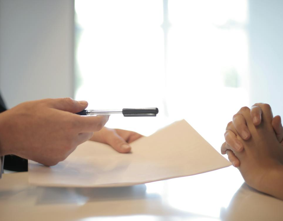 Nanda & Associate Lawyers Canada - A person handing over a document