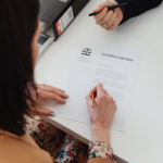 Nanda & Associate Lawyers Canada - A person signing a document