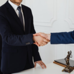 Nanda & Associate Lawyers Canada - Immigration lawyer shaking hands with a satisfied client after successful legal assistance.