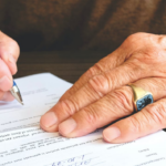Nanda & Associate Lawyers Canada - A person signing a document