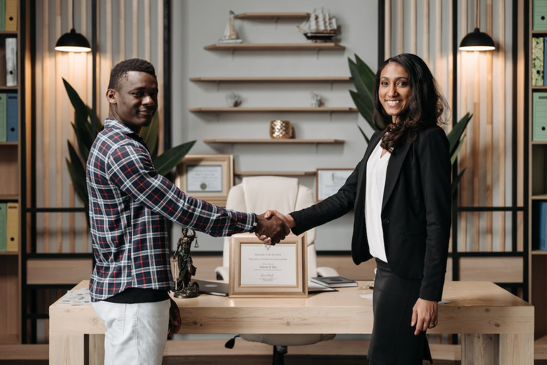 Nanda & Associate Lawyers Canada - Lawyer and happy client shaking hands after successfully acquiring permanent residence in Canada