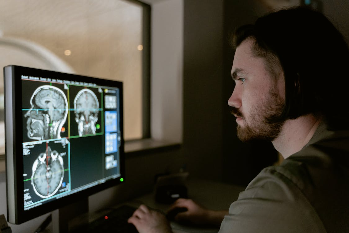 Nanda & Associate Lawyers Canada - A person looking at brain scans