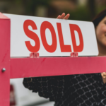 Nanda & Associate Lawyers Canada - A person near a sold sign