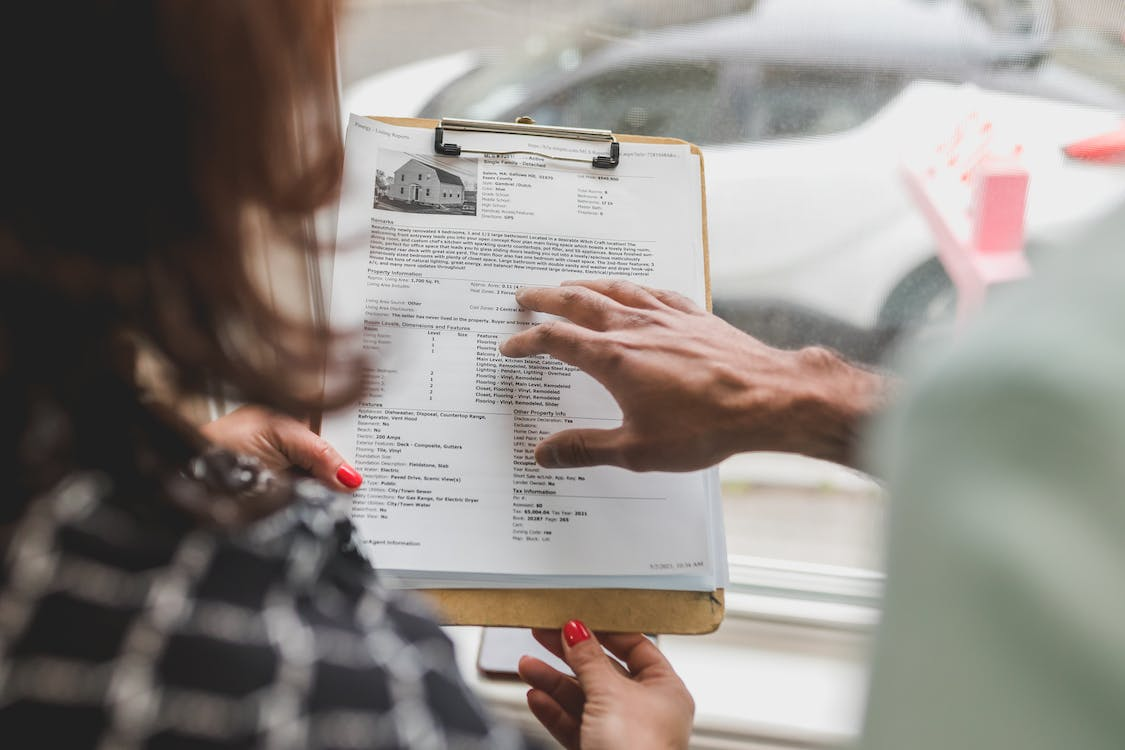 Nanda & Associate Lawyers Canada - A woman looking a house’s documents