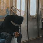 Nanda & Associate Lawyers Canada - Stressed person on a train seat