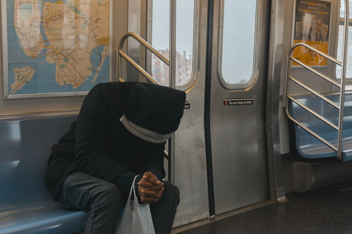 Nanda & Associate Lawyers Canada - Stressed person on a train seat